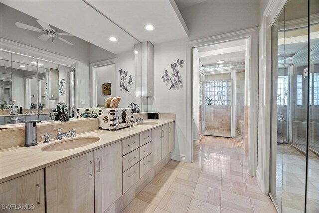 bathroom with tile patterned flooring, vanity, and ceiling fan