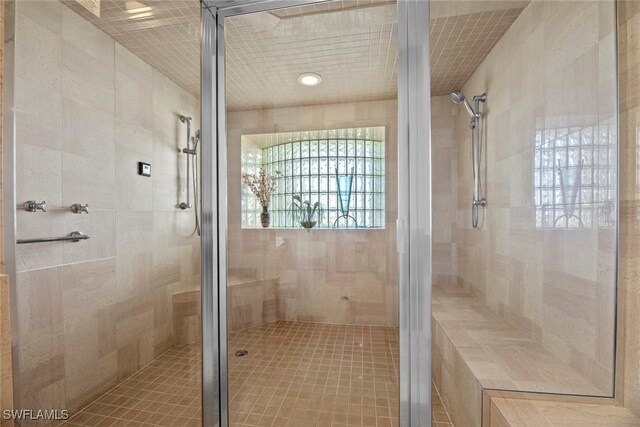 bathroom with a shower with shower door