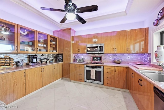 kitchen with decorative backsplash, sink, stainless steel appliances, and crown molding