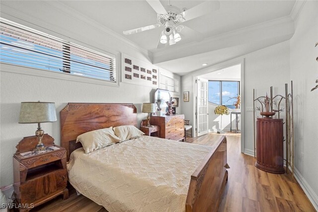 bedroom with ceiling fan, ornamental molding, and hardwood / wood-style flooring