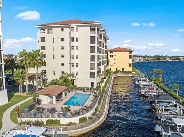 view of property featuring a water view and a community pool