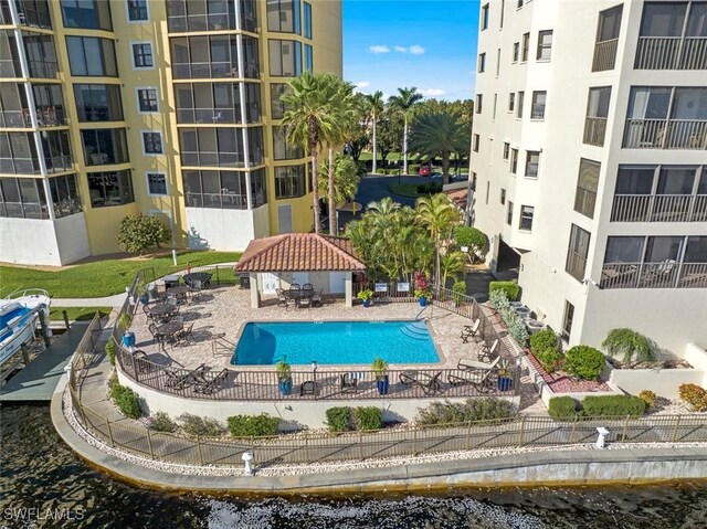 view of pool featuring a gazebo, a water view, and a patio