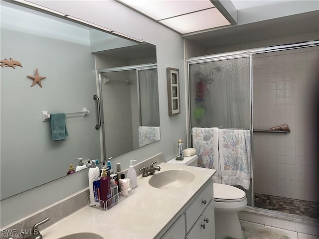 bathroom featuring a stall shower and a sink