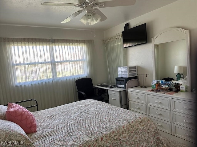 bedroom featuring multiple windows and ceiling fan