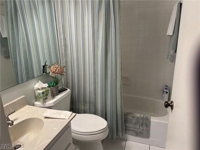 full bathroom featuring tile patterned floors, vanity, toilet, and shower / bath combo with shower curtain