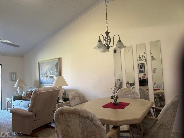 dining room featuring high vaulted ceiling, ceiling fan with notable chandelier, and carpet floors