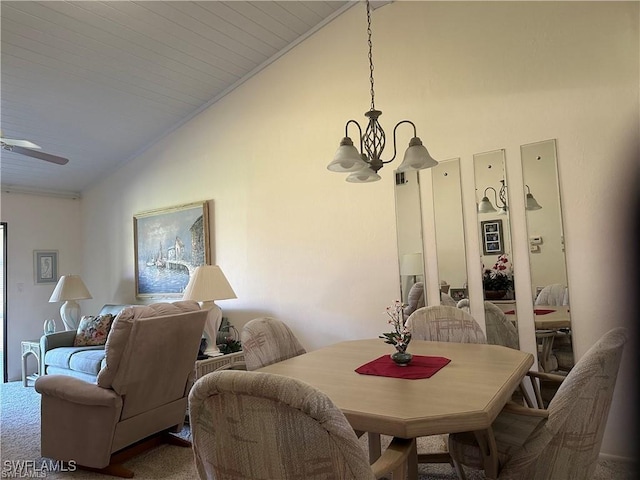 dining room with carpet floors, vaulted ceiling, and ceiling fan with notable chandelier