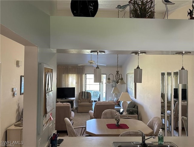 dining room featuring ceiling fan, wood ceiling, carpet, and sink