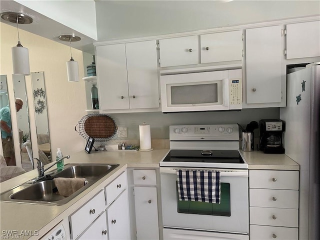 kitchen featuring light countertops, white appliances, a sink, and white cabinetry