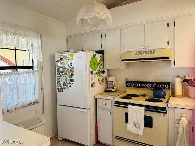 kitchen with white appliances, ventilation hood, vaulted ceiling, light tile patterned floors, and white cabinetry