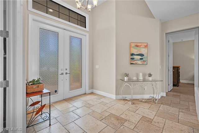 entrance foyer featuring french doors and a chandelier