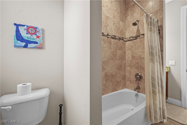 bathroom with shower / bath combo with shower curtain and toilet