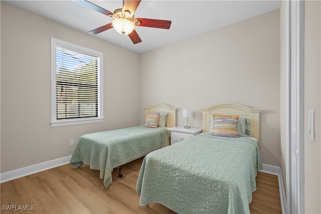 bedroom with ceiling fan and light hardwood / wood-style floors