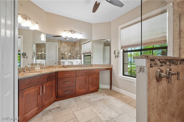 bathroom with vanity, a tile shower, and ceiling fan