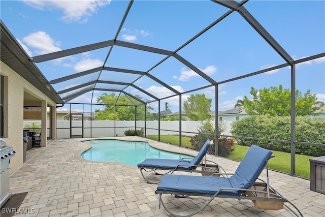 view of pool featuring a lanai and a patio