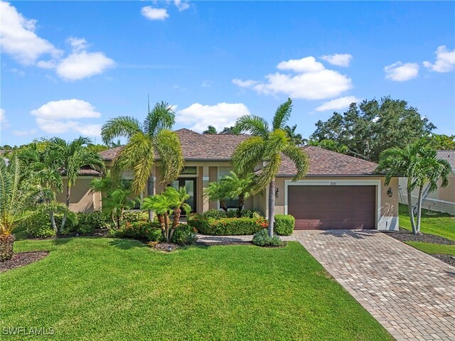 view of front of house featuring a front lawn and a garage