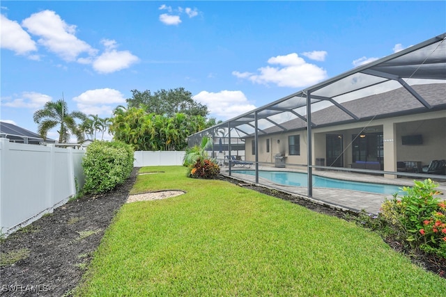 view of yard featuring a fenced in pool and a lanai