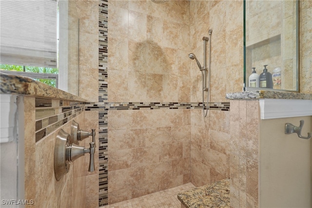 bathroom with tiled shower