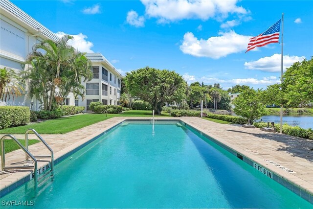 view of pool featuring a yard