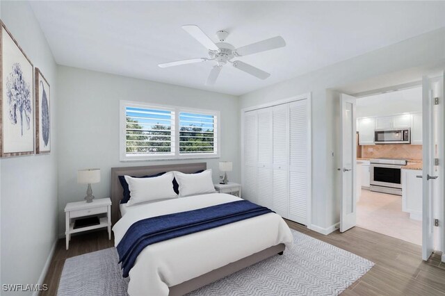 bedroom with ceiling fan, a closet, and light wood-type flooring