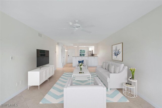 tiled living room with ceiling fan