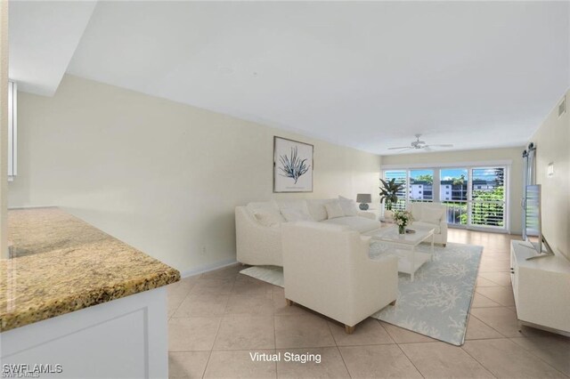 living room with ceiling fan and light tile patterned flooring