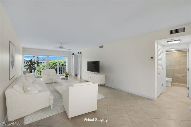 tiled living room featuring ceiling fan