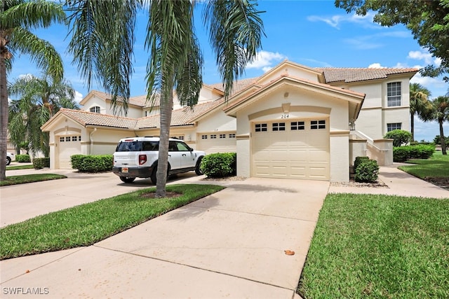 mediterranean / spanish-style home with a garage and a front lawn