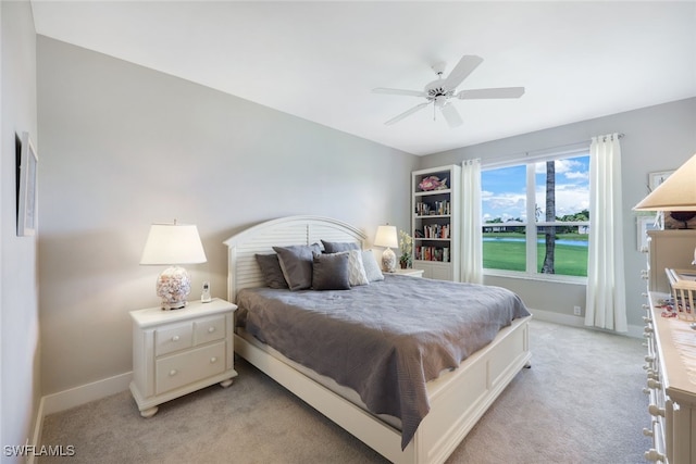 bedroom featuring light carpet and ceiling fan