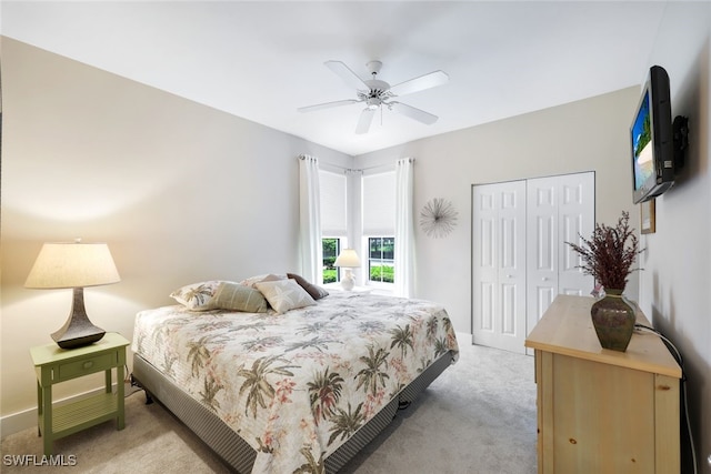 carpeted bedroom with ceiling fan and a closet