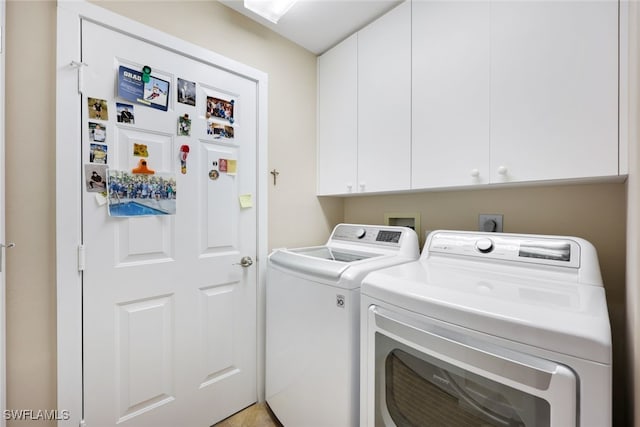 washroom featuring cabinets and separate washer and dryer