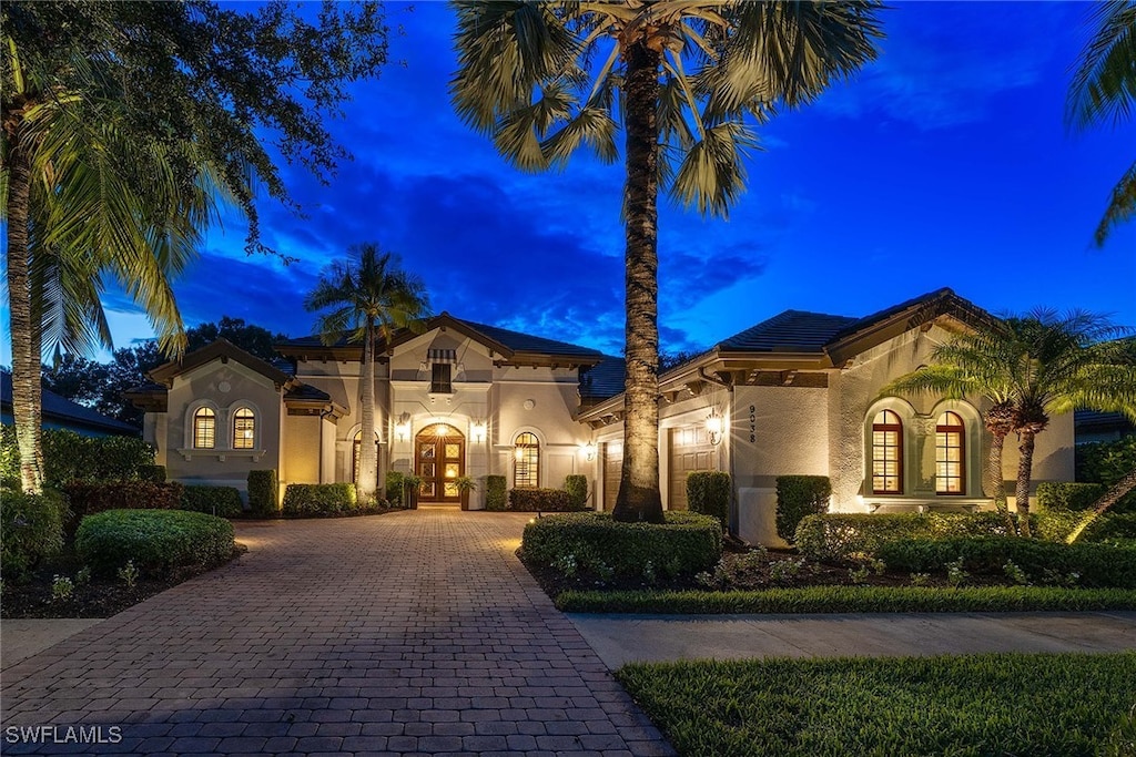 mediterranean / spanish home featuring french doors