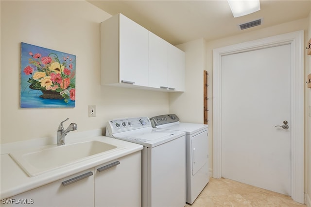 laundry room featuring washer and dryer, light tile patterned flooring, cabinets, and sink