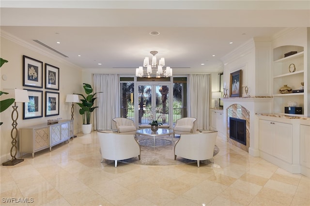 living room featuring a notable chandelier, crown molding, and built in shelves