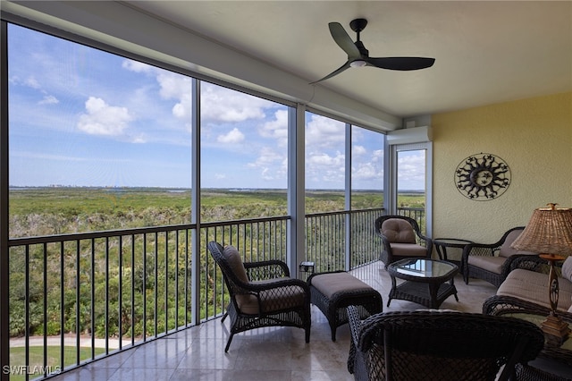 sunroom featuring ceiling fan