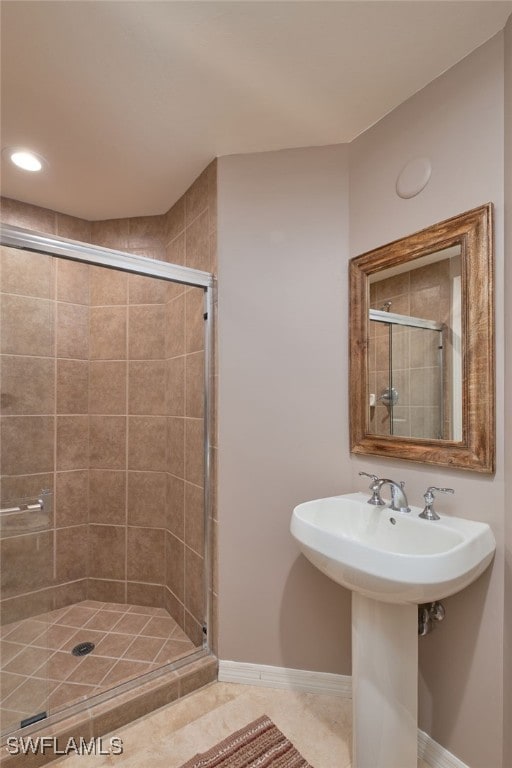 bathroom with tile patterned floors, sink, and a shower with shower door