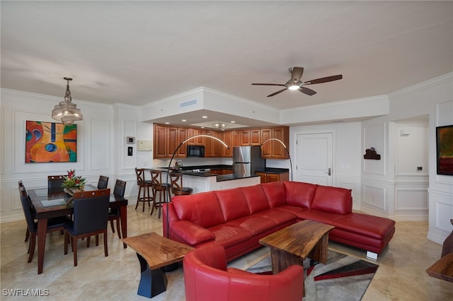 living room featuring ceiling fan and ornamental molding