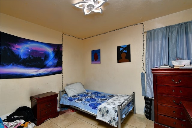 tiled bedroom featuring ceiling fan