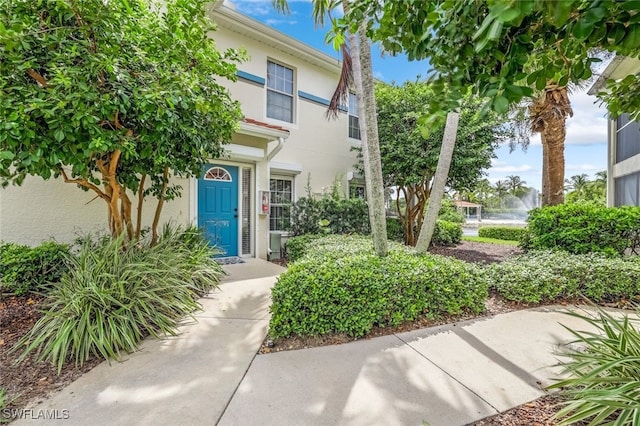 doorway to property with stucco siding