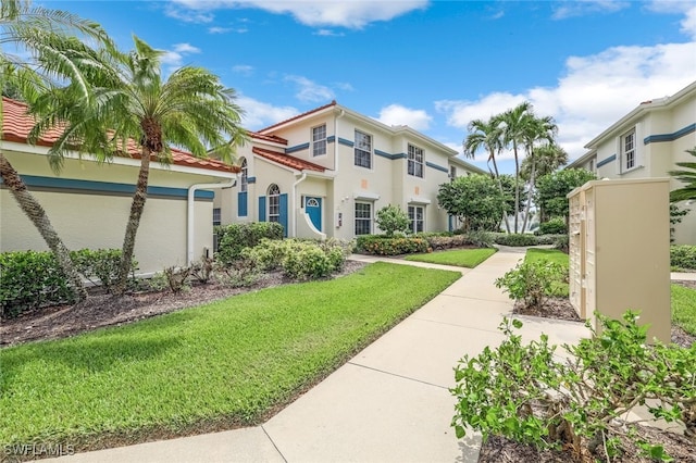 mediterranean / spanish-style home featuring a front lawn