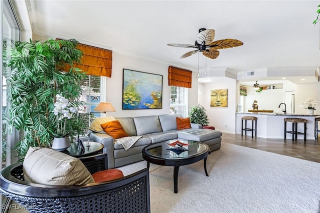 living room featuring crown molding, plenty of natural light, and ceiling fan