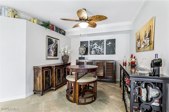 dining area with ceiling fan and crown molding