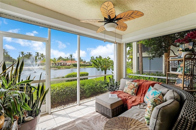 sunroom featuring a water view and ceiling fan