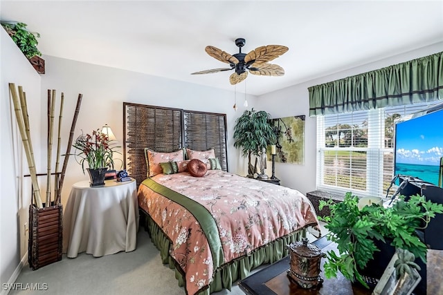 bedroom featuring ceiling fan and carpet