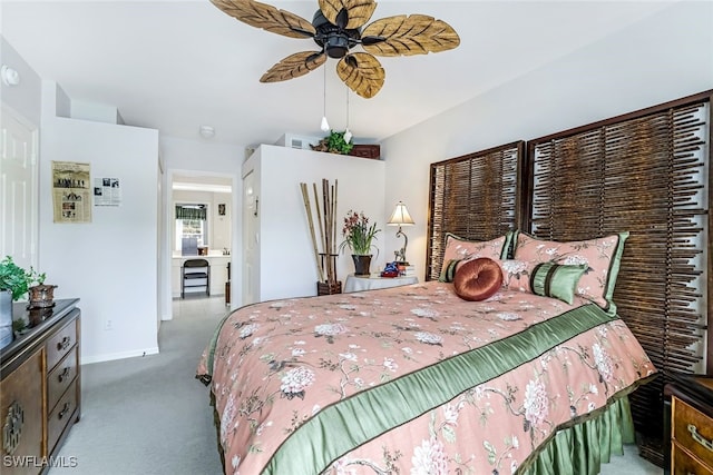 carpeted bedroom with ceiling fan and baseboards