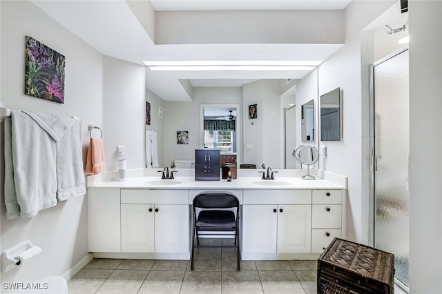 bathroom featuring tile patterned flooring, a shower with door, ceiling fan, and vanity