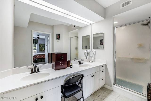 bathroom with tile patterned floors, a shower with door, and vanity