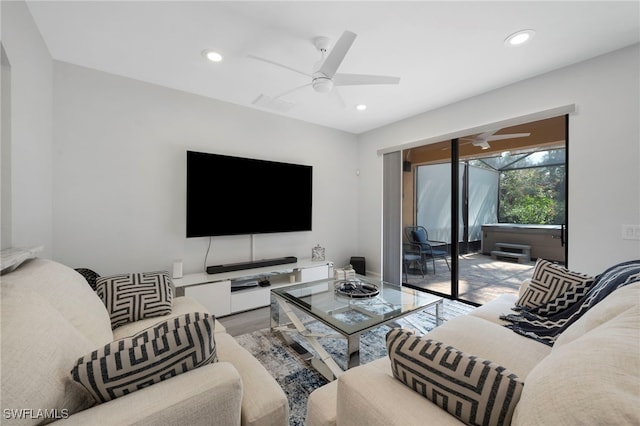 living room with ceiling fan and wood-type flooring