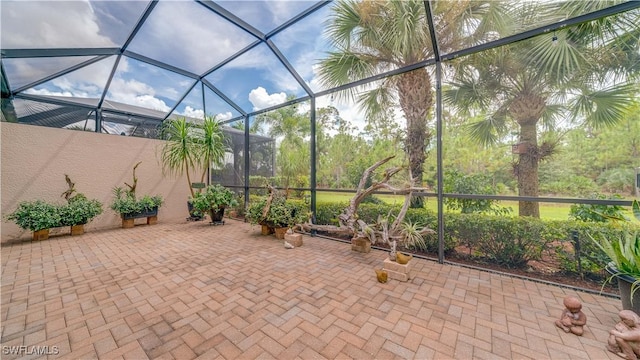 view of patio featuring glass enclosure