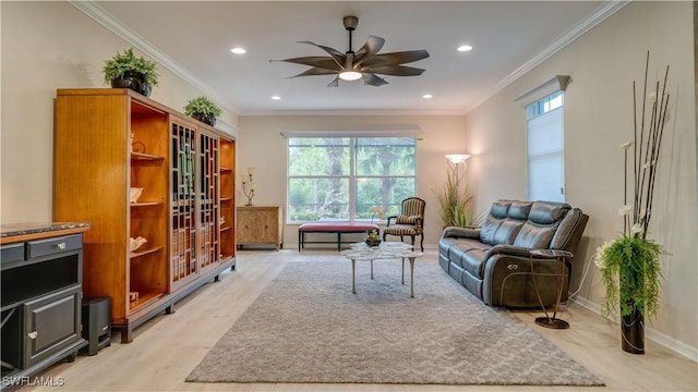 living room featuring light hardwood / wood-style floors, plenty of natural light, and crown molding